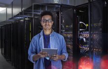 Portrait confident male IT technician with digital tablet in server room — Stock Photo