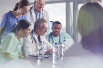 Surgeon, doctors and nurses meeting, using laptop in hospital meeting — Stock Photo