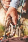 Close up rock climber holding knotted rope — Stock Photo