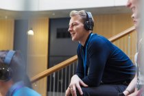 Smiling, attentive man listening to headphones in conference audience — Stock Photo