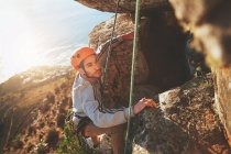Focused male rock climber climbing rock — Stock Photo