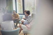 People listening to man in group therapy session — Stock Photo