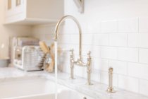 Water running from kitchen sink faucet — Stock Photo