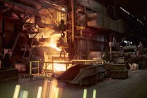 Molten furnace in dark steel mill — Stock Photo