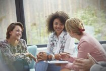 Smiling women talking in group therapy session — Stock Photo