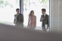 Business people walking and talking in office — Stock Photo
