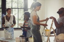 Friends painting living room — Stock Photo