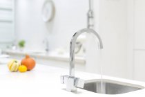 Modern stainless steel kitchen faucet and sink — Stock Photo
