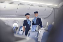 Portrait smiling, confident female flight attendants on airplane — Stock Photo