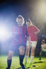 Young female soccer players practicing agility sports drill on field at night — Stock Photo