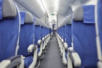 Empty blue seats in a row in airplane — Stock Photo