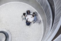 View from above architects meeting in atrium courtyard — Stock Photo