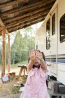 Portrait shy girl hiding face with hands outside rural camper — Stock Photo