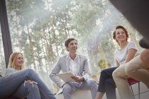 Smiling people talking in group therapy session — Stock Photo