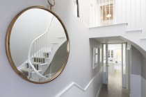 Reflection of foyer staircase in round mirror — Stock Photo