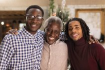 Portrait grandfather and grandsons hugging — Stock Photo