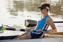 Determined female rower rowing scull — Stock Photo
