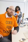 Portrait confident hacker coding for charity at hackathon — Stock Photo