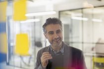 Confident, smiling creative businessman brainstorming in office — Stock Photo