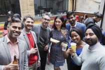 Portrait smiling friends drinking at party on patio — Stock Photo