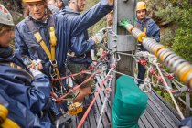People preparing zip line equipment — Stock Photo