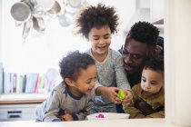 Happy father playing with children at home — Stock Photo