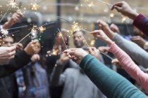 Friends celebrating with sparklers — Stock Photo
