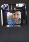 Focused male designer watching 3D printer — Stock Photo