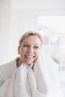 Smiling mature woman drying face with towel — Stock Photo