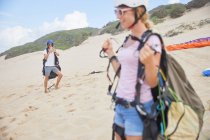 Парапланеристы с оборудованием на пляже — стоковое фото