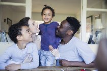 Portrait happy multiracial family at table — Stock Photo
