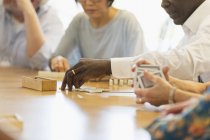 Senior friends playing games at table in community center — Stock Photo