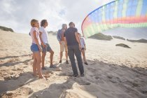 Parapentes con paracaídas en la playa soleada - foto de stock