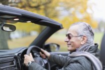 Senior man driving convertible car — Stock Photo