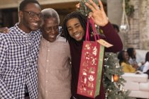 Grandsons surprising grandfather with Christmas gift — Stock Photo
