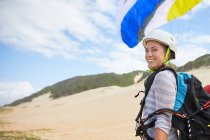 Portrait smiling, confident young female paraglider on beach — Stock Photo