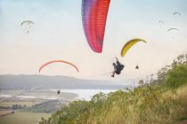 Paragliders in sky over landscape — Stock Photo