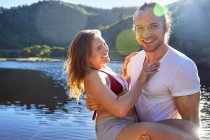 Portrait romantic, carefree couple at sunny summer lake — Stock Photo