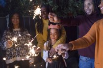 Family celebrating with sparklers — Stock Photo