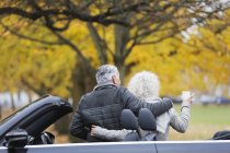Couple sénior avec cabriolet au parc d'automne — Photo de stock