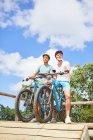 Father and son mountain biking at obstacle course — Stock Photo