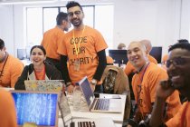 Portrait confident hackers coding for charity at hackathon — Stock Photo