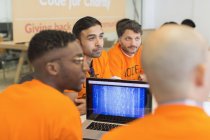 Dedicated hackers coding for charity at hackathon — Stock Photo