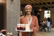 Portrait smiling, confident woman serving lemonade and sangria — Stock Photo