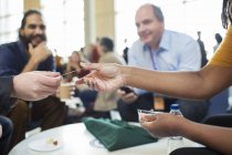 Business people networking, exchanging business cards at conference — Stock Photo