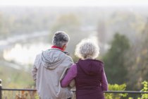 Active senior couple looking at view in nature — Stock Photo