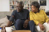 Senior couple checking blood pressure — Stock Photo