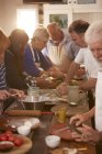 Amici anziani attivi che fanno la pizza in classe di cucina — Foto stock