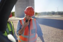 Female worker using walkie-talkie at power plant — Stock Photo