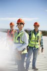 Portrait smiling, confident engineers at sunny power plant — Stock Photo